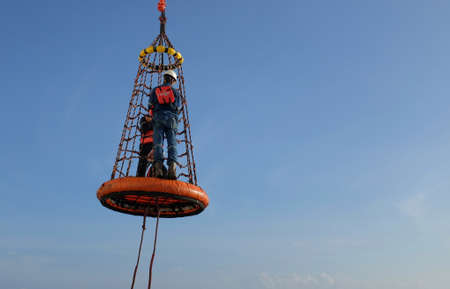 Gulf of Thailand, Offshore workers being lifted by the personal transfer basket.のeditorial素材
