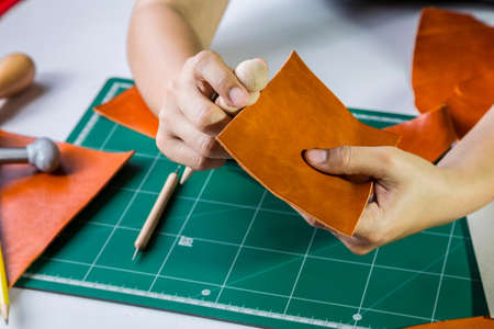 Leather craft maker in workhopの写真素材