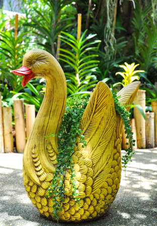 Swan sculpture with plant at the gardenの写真素材