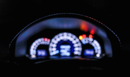 Defocused luxury car dashboard panel and speedometer