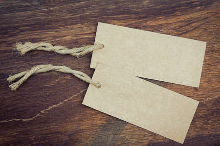 Blank price tag  with rustic wooden style background in vintage toneの写真素材