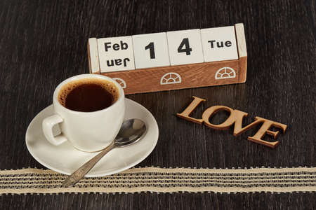 Cup of Coffee with Saucer on a Wooden Tableの写真素材