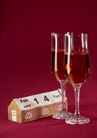 Two Wineglasses of Wine and Wooden Calendarの写真素材