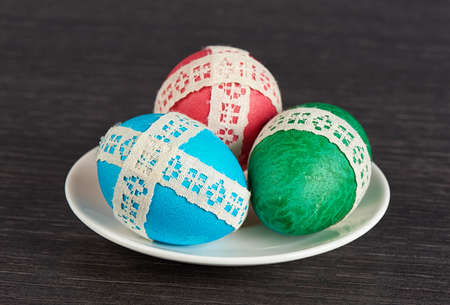 easter eggs in saucer on the wooden tableの写真素材