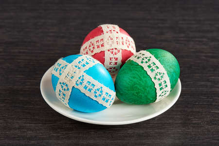 easter eggs in saucer on the wooden tableの写真素材