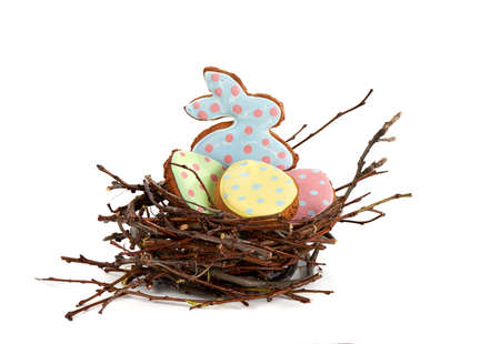 easter bunny and easter gingerbread in the nest on white background