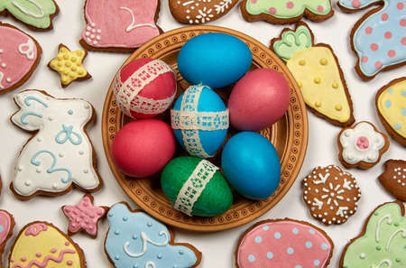 easter eggs in wooden plate and easter gingerbreadの写真素材