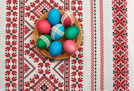 easter eggs in wooden plate on the towelの写真素材