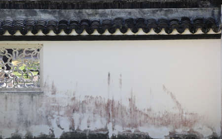 The ancient Chinese wall in white has a black roofの写真素材