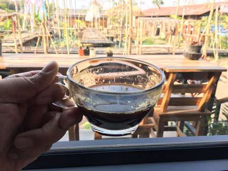 Americano coffee and a window glassの写真素材