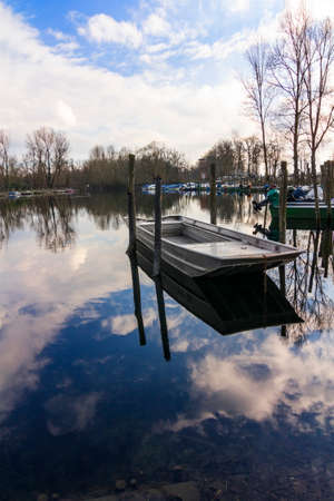 ship on a lake with sky reflectionの写真素材