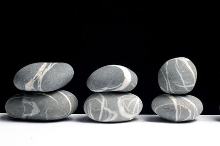 row of Stack of zen stones on blackの写真素材