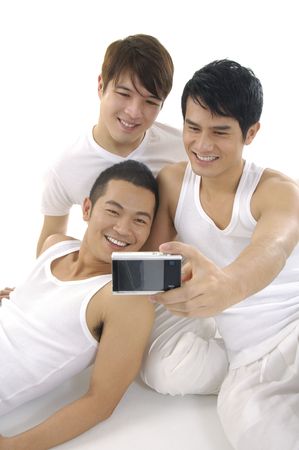 Friends taking portrait with digital cameraの写真素材