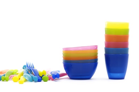Stack of color plastic dishes, knife ,fork, spoonの写真素材