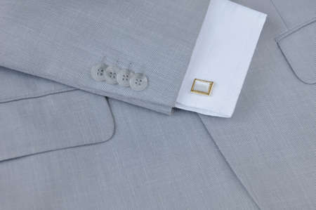 Fragment of men's suit with cuffs and cuff links, close-up