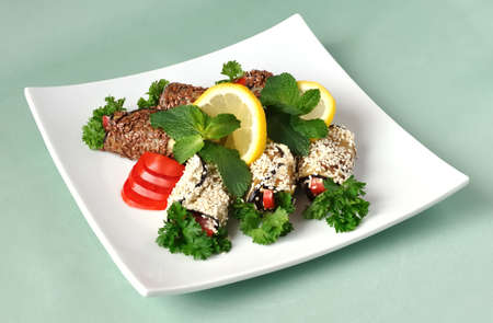 Rolled eggplant with tomatoes in sesame and flax seedの写真素材