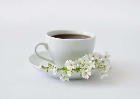 A cup of black coffee with flowers on a gray backgroundの写真素材
