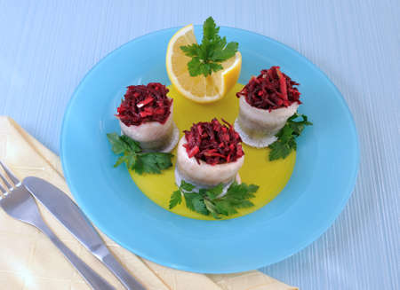 Herring fillet stuffed with beet-apple stuffing with herbsの写真素材