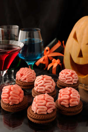 Funny cookie with brains of marzipan on Halloweenの写真素材