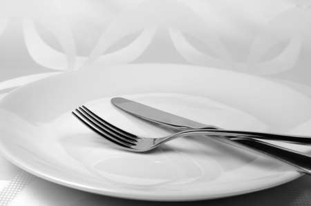 Cutlery knife and fork on a plateの写真素材