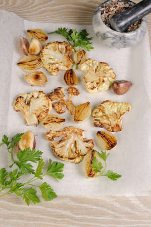 Warm appetizer of fried pieces of cauliflower with garlic and onionの写真素材