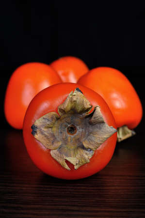 Group persimmon sprinkled on the table closeupの写真素材