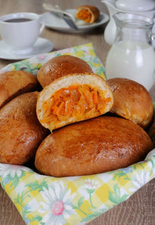 Break patty with cabbage on a pile of pies