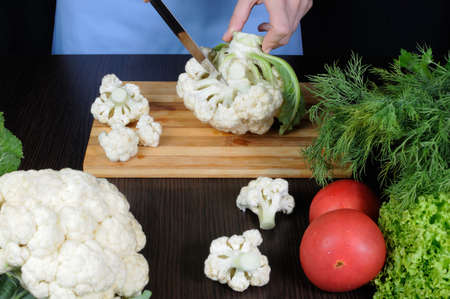 Cut into florets cauliflower on a cutting boardの写真素材
