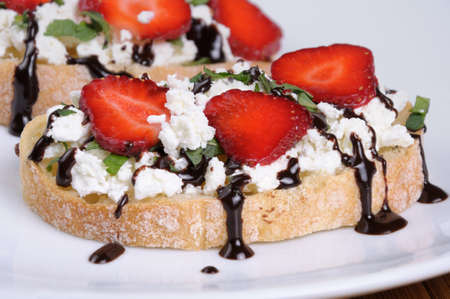 Sandwich  ricotta and mint with strawberry slices and chocolate toppingの写真素材