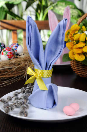 Napkin folded as an Easter bunny on a plate