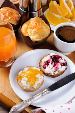 Breakfast of bun with ricotta orange and cherry jamの写真素材