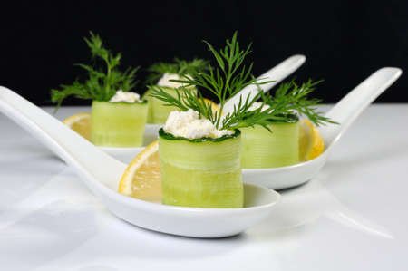 Cucumber canape with ricotta and lemon slice close-up. Horizontal shot. Foreground.の写真素材