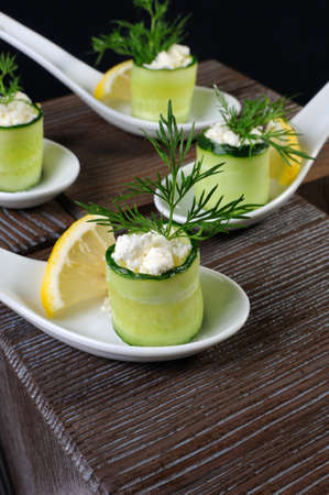 Cucumber canape with ricotta and lemon slice close-up.の写真素材