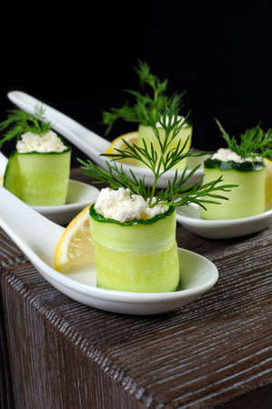 Cucumber canape with ricotta and lemon slice close-up.の写真素材
