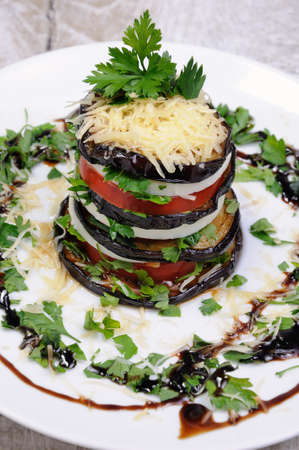 Appetizer from eggplant , slices of mozzarella combined in a pile with tomatoes spilled with herbs, seasoned   Parmesan cheeseの写真素材