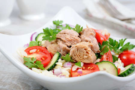 Salad from canned tuna with tomatoes, cucumber and orzoの写真素材