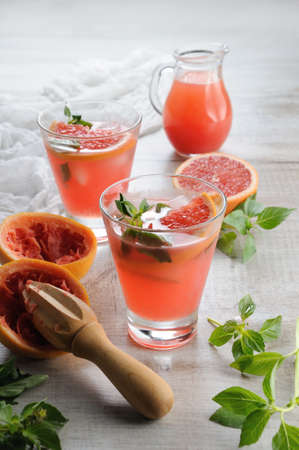 Cocktail of juice, squeezed red grapefruit and leaves of the delicate basil lemon.What could be better in a flyable, hot, sunny day?の写真素材