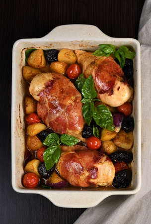 Chicken breast stuffed with goat cheese with spinach, wrapped in prosciutto, with slices of baked...
