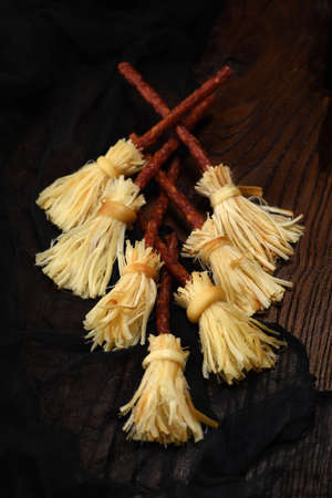 Witches Broom of smoked cheese suluguni and salami. Original idea Halloween snack.