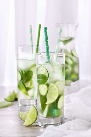 Refreshing  infused  water with cucumber, mint and lime . Summer beverage cocktail lemonade. Healthy drink and detox concept.の写真素材
