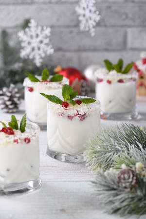 White Christmas mojito made from liqueur, tequila, coconut milk with pomegranate seeds, coconut flakes and refreshing mint.の写真素材