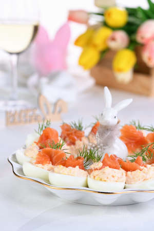 Appetizer of eggs stuffed salmon pate and yolks with salmon slices. Idea Easter table