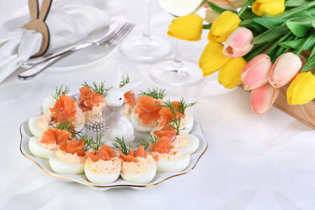 Appetizer of eggs stuffed salmon pate and yolks with salmon slices. Idea Easter table
