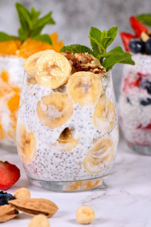 Chia dessert with Greek yogurt and banana slices and nuts. Absolutely helpful. Perfect breakfast or snack. Suitable for vegans and gluten free.の写真素材