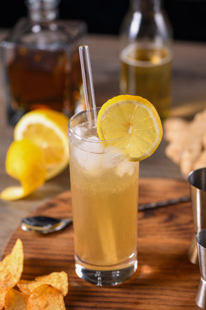 Whiskey cocktail with ginger beer, garnished with lemon