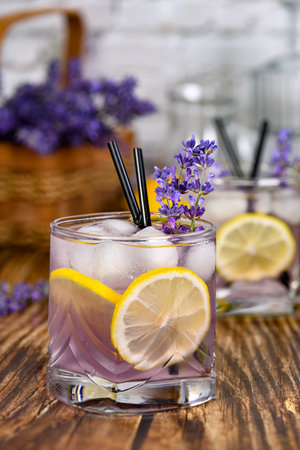 Margarita cocktail with lavender flavor. Garnished with lemon wedges and lavender sprigsの写真素材