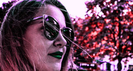 Beautiful colorful photo with woman in the park. Woman with green lipsの写真素材