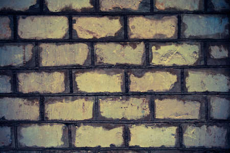 Very old brick wall covered with brown patinaの写真素材