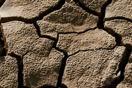 Cracked by the heat long lifeless soilの写真素材
