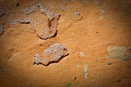 The old wall covered with plaster crashed